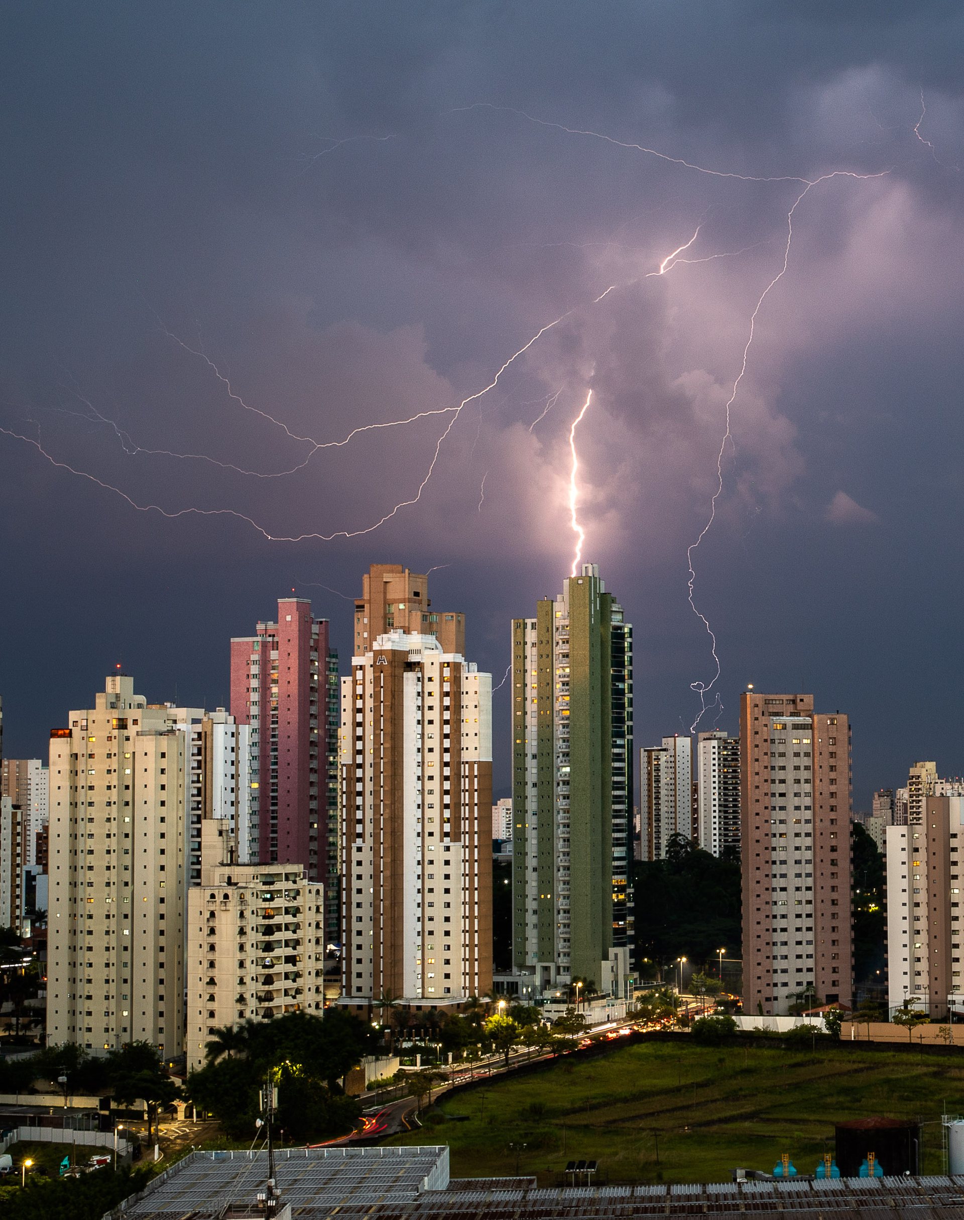 Lightning strikes near towers in Tatuapé, São Paulo, during a dramatic stormy sky.