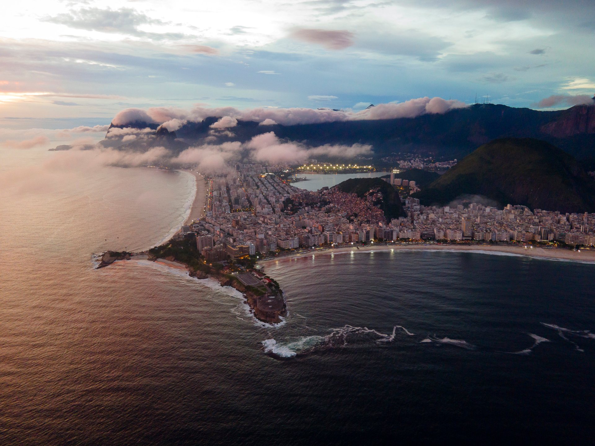 Aerial view of Arpoador at sunset, showing the dramatic coastline where Ipanema meets Copacabana in Rio de Janeiro.
