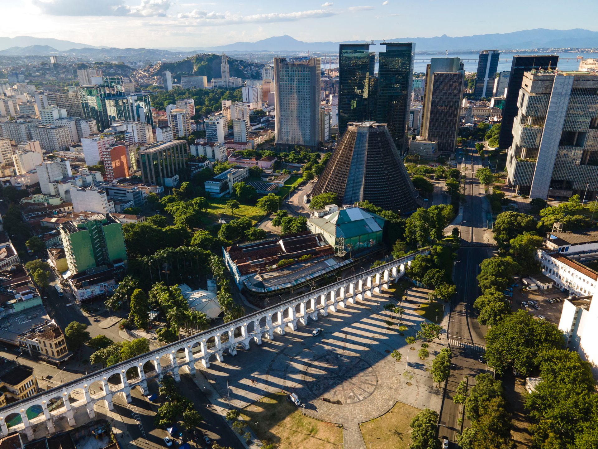 Drone photo of Rio’s historic city center, featuring the Arcos da Lapa viaduct and the brutalist Cathedral of São Sebastião.