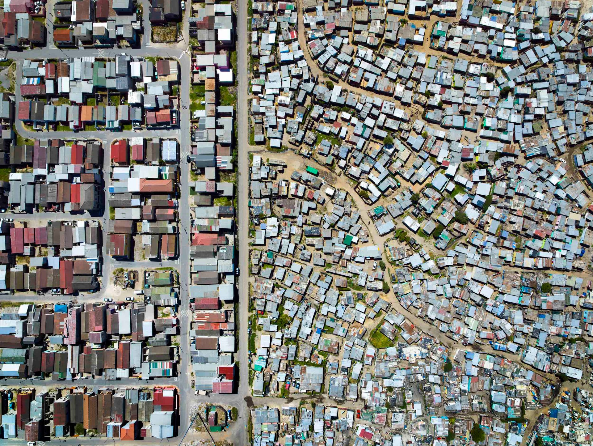Shacks next to houses in cape town south africa